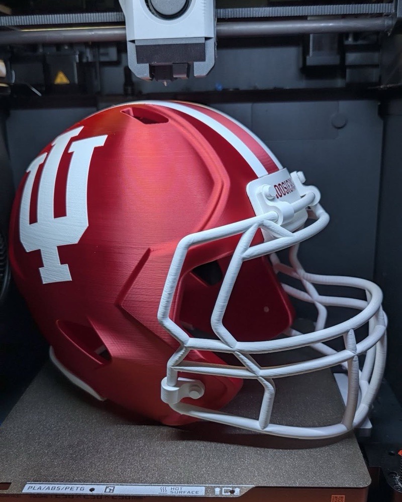 Full-size 3D printed football helmet in red and white, fresh off the printer at KB Prints in Hartford City, Indiana