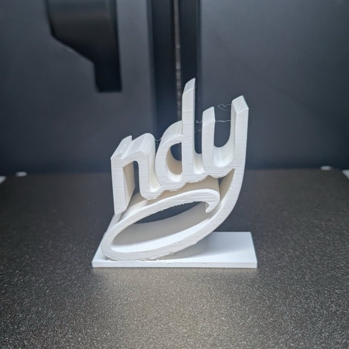 3D printed Indy script sign on the print bed at KB Prints