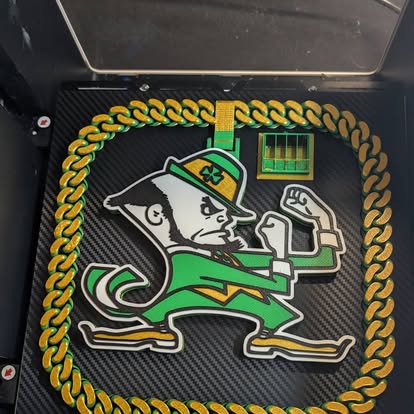 3D printed multicolor mascot plaque framed by a gold chain, printed by KB Prints in Hartford City, Indiana