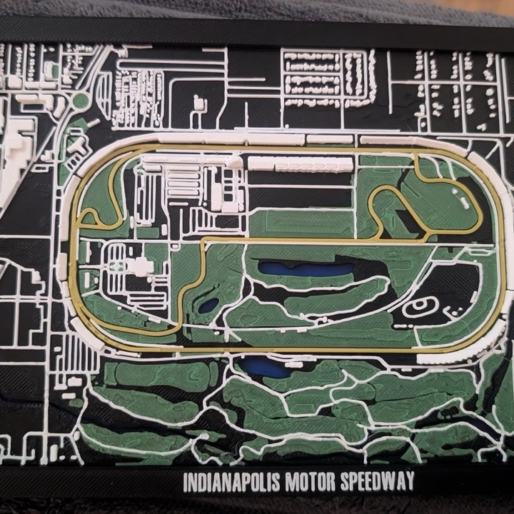 3D printed layered map of a famous Indiana race track with raised roads and infield, framed as wall art